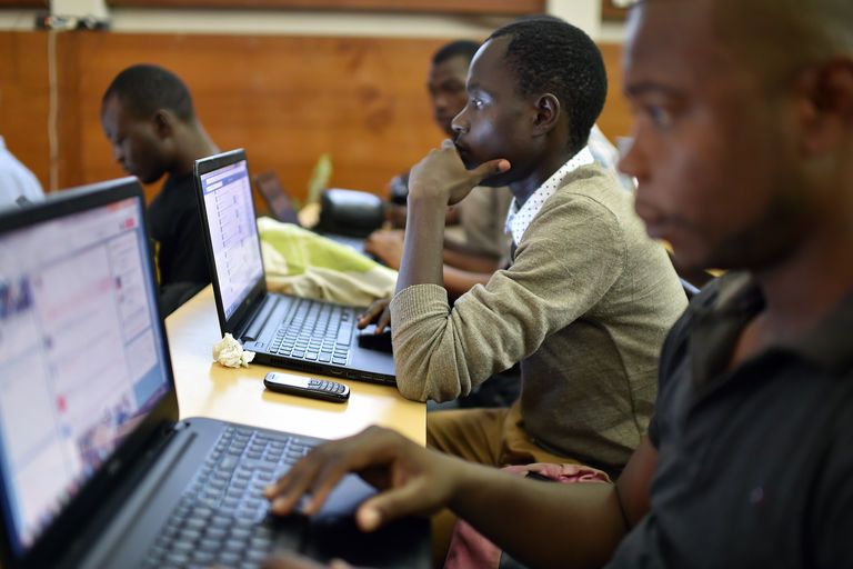[Image étudiants noirs souriants travaillant sur ordinateur]